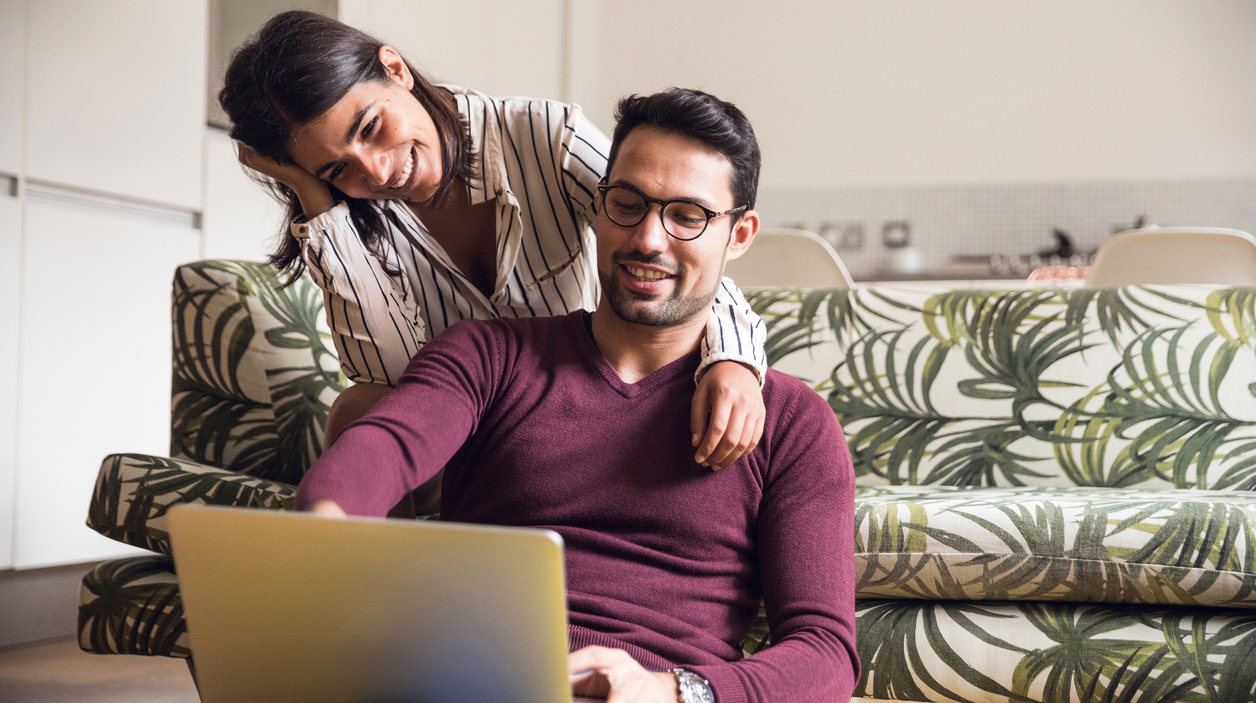 Couple at home using laptop computer