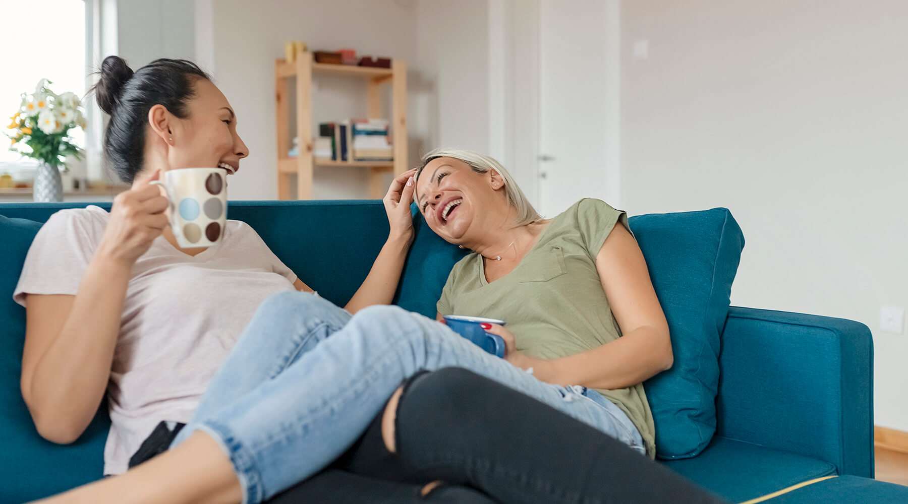 Women on couch laughing