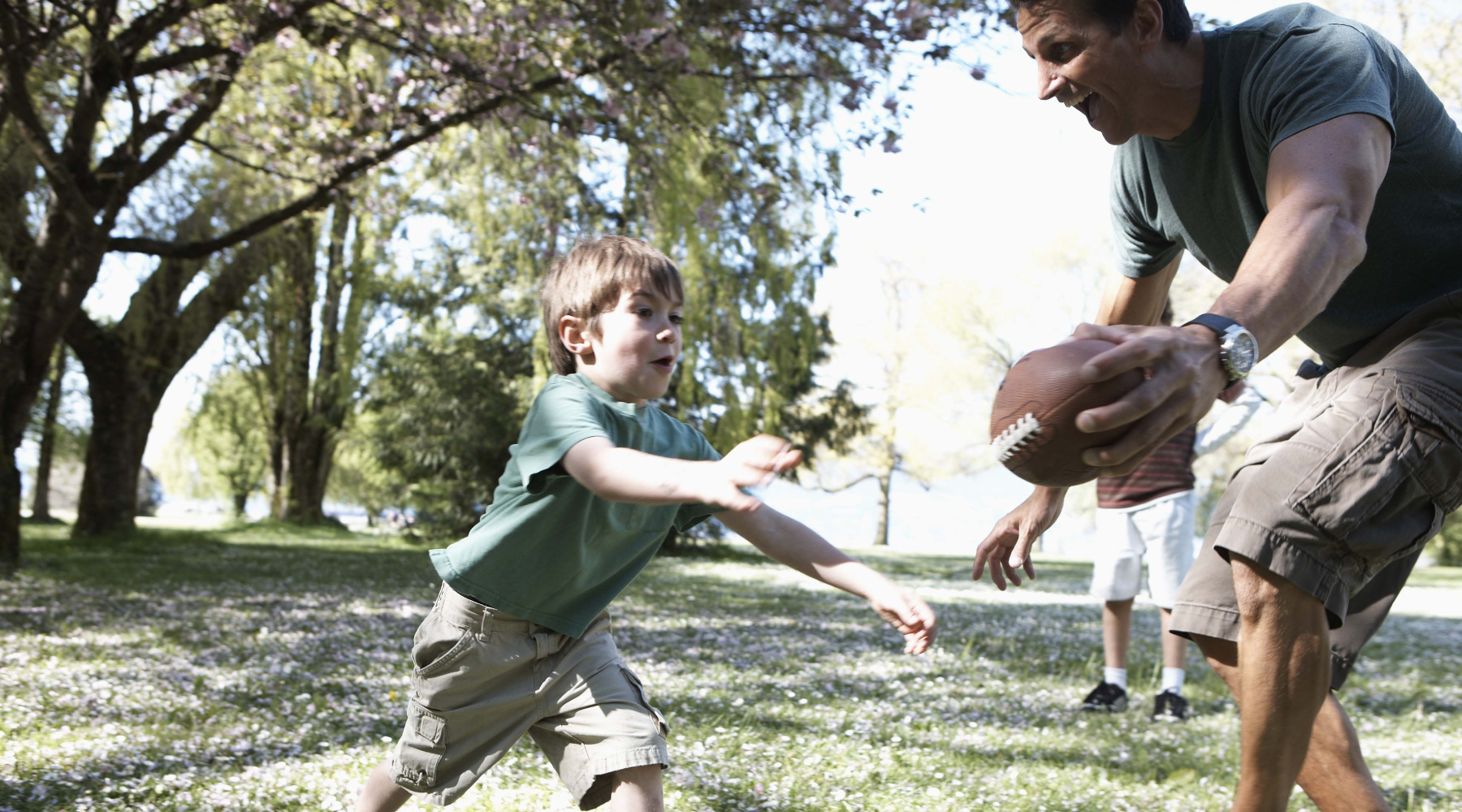 Dad and son playing football