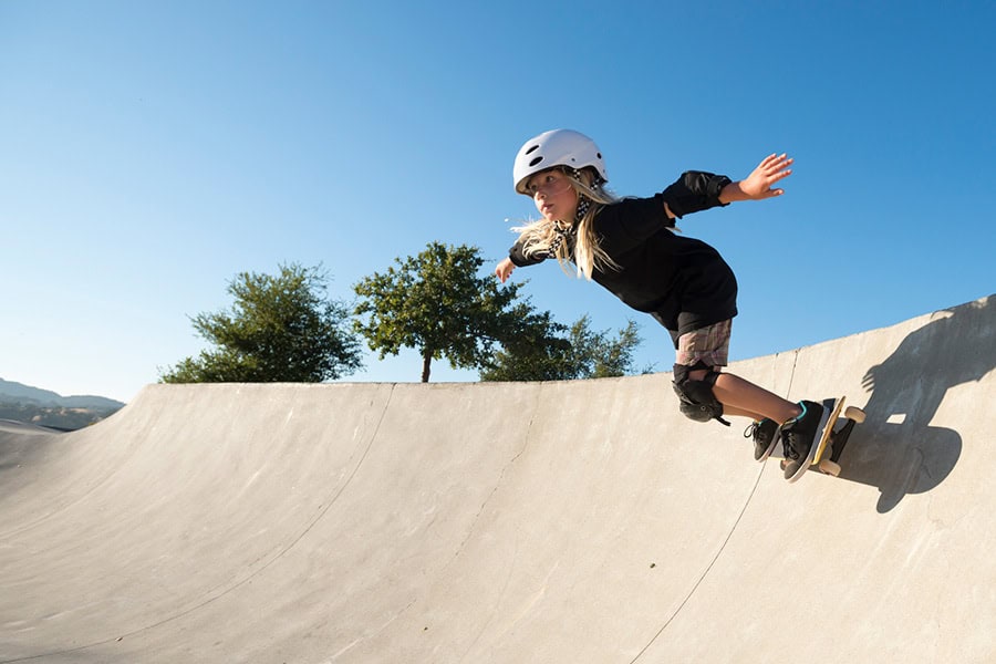 Young girl skateboarding at park