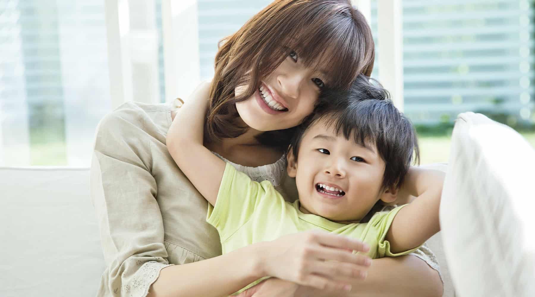 Happy mom and child on couch