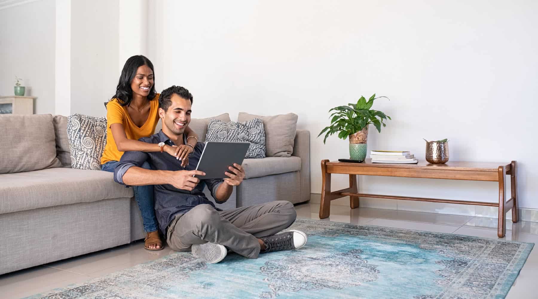 Couple at home looking at tablet